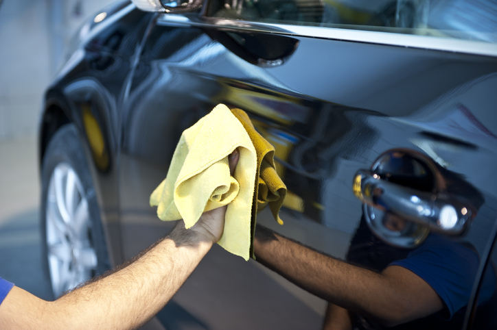 wiping car with microfiber cloth